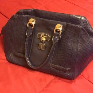 Navy blue Guess bag w/ outside zip pocket.